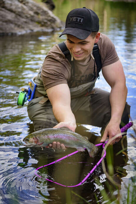 Angler's holding a freshly caught trout